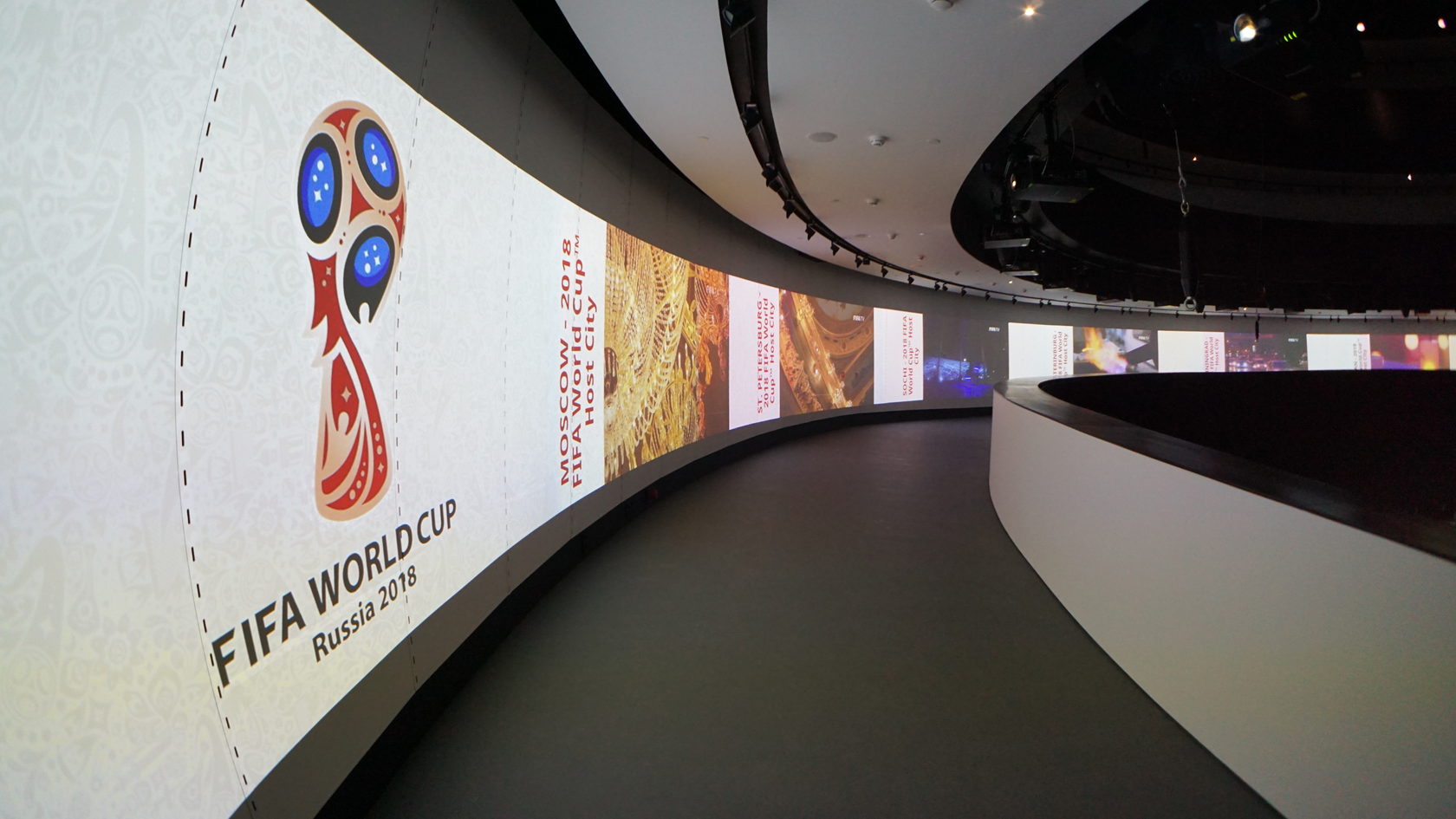 Interior design of Matrex multimedia center showing ambient lighting integrated with SpinetiX digital signage panels and interactive surfaces